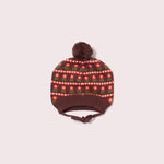 Knitted hat with a patterned top and brown brim on a light pink background